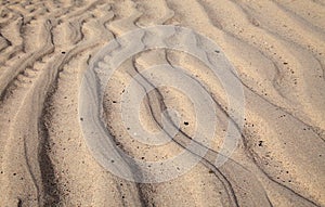 Natural sand pattern created by a flow of tide and ripples