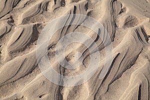 Natural sand pattern created by a flow of tide and ripples