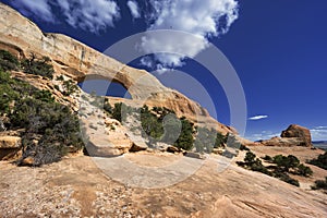 Natural sandstone Wilson Arch arch in Moab, USA photo