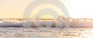 Natural scene of strong wave hit the beach with bright sunlight