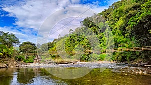 natural scenery, river between pine forests and blue sky full of clouds