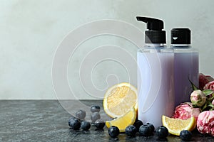 Natural shower gels and ingredients against white textured background