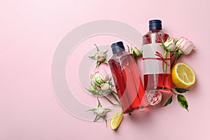 Natural shower gels and ingredients on pink background