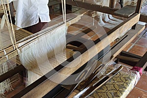 Natural silk farming and handcrafted manufacture of silk artifacts -ladies handweaving ancient patterns in silk on traditional loo