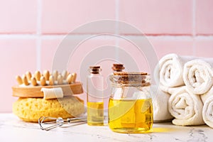 . Natural skin care products. Bottles with organic wheat germ oil against pink tiled wall.