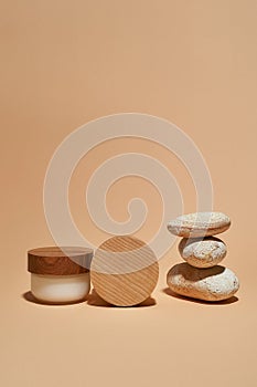 Natural skincare cream next to stack of stones