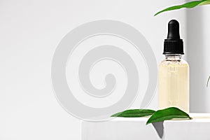 Natural skincare product in glass bottle with dropper. Serum for woman facial skin. Herbal mineral cosmetic, vitamin body oil on