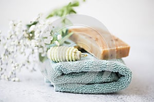 Natural skincare and spa products with handmade natural soap, jade face roller and cotton towel closeup , spa and skincare concept