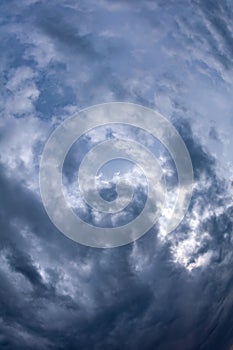 Natural sky composition. Dark ominous grey storm rain clouds. Dramatic sky. Overcast stormy cloudscape. Thunderstorm