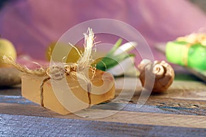 Natural soap, candles, flower, sea stones and shells on a wooden table