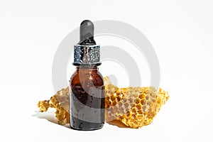 Natural soap and serum for skin care with honey and honeycombs on a white background. honey oil in a small jar.