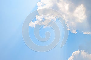 Natural soft clouds pattern and sunshine ray on blue sky background