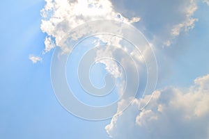 Natural soft clouds pattern and sunshine ray on blue sky background