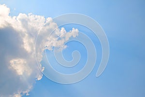 Natural soft clouds pattern and sunshine ray on blue sky background