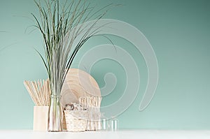 Natural soft light accessories for home decor - dried plant, wicker basket, sticks, bamboo plate, bouquet of reed, glass bottle.