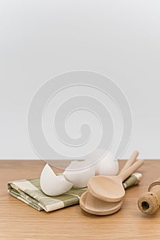 natural solid wood kitchen tools and table napkin with eggs on a wooden background