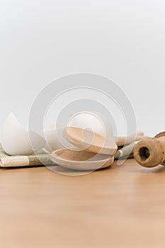 natural solid wood kitchen tools and table napkin with eggs on a wooden background
