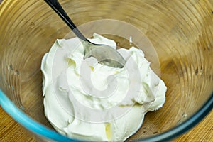 Natural sour cream in a glass plate