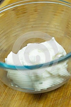 Natural sour cream in a glass plate