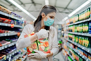 Natural source of vitamins and minerals.Apple juice antioxidants.Woman wearing face mask buying in supermarket.Woman preparing