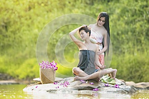 Natural Spa,Beautiful Woman relaxing in outdoor Massage with tropical flowers,
