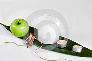 Natural spa beauty treatment cleansing products with apple on white background.