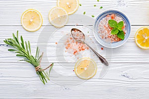 Natural spa ingredients and body scrub. Himalayan rock salt with scented herbs on wooden background