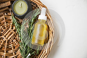 Natural spa with rosemary herb and oil,scented candle, top view of natural home skincare products