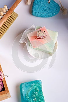 Natural   spa set with rose essence, massage brush and soaps on white  background. close up