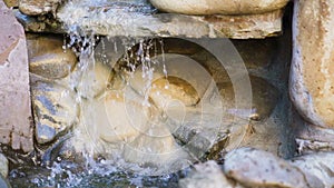 Natural spring drops fall in slow motion. Water flows dribbles and fall in drops