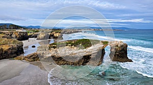 Natural stone arch on Playa de Las Catedrales, Spain photo