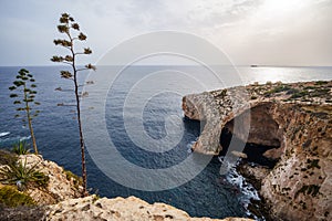 Natural stone arch and sea caves at Blue Grotto, Malta