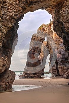 Natural stone archs on Playa de Las Catedrales, Spain photo