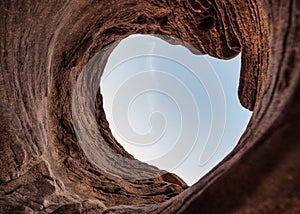 Natural stone hole cave of eroded surface by water with blue sky in national park