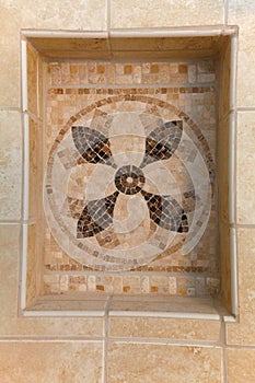 Natural stone tiles mosaic with shelve in bathroom.