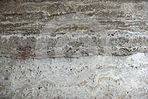 Natural stone travertine gray-beige with parallel stripes is called Travertino Titanium photo