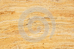 Natural stone travertine yellow color with an interesting pattern, called Travertino Giallo photo