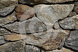 Natural stone wall in a garden photo