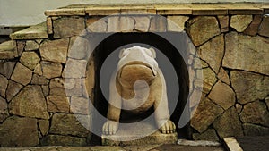 natural stone wall with giant frog statue as a guardian symbols