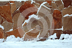 Natural stone wall from pieces covered with snow - Image
