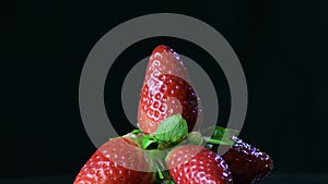 Natural strawberries fruit gyrating in a mountain of strawberries