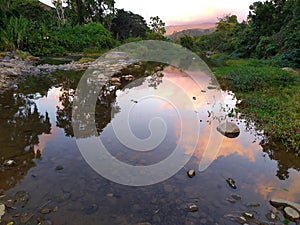 Natural sunset landscape with river and clouds. Paisaje natural de atardece con rÃÂ­o y nubes photo