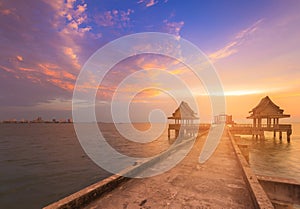 Natural sunset sky over seacoast skyline with walking path