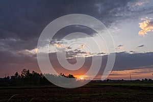 Natural sunsets over Bright Dramatic Sky and dark ground.