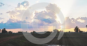 Natural sunsets over bright dramatic sky and dark ground.