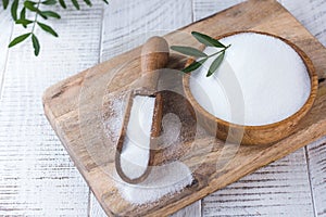Natural sweetener in a wooden spoon. Sugar substitute. Erythritol