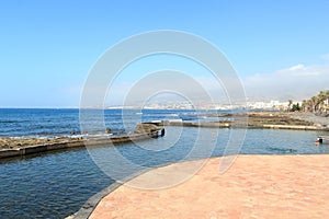 Natural swimming pool and Atlantic Ocean coastline panorama of holiday resort Playa de las Americas on Canary Island Tenerife,