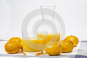 Natural tangerine orange juice on white