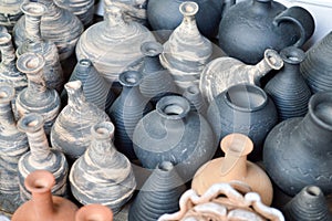 Natural traditional clay pottery beautiful old kitchen appliances, dishes, jugs, vases, pots, mugs. The background