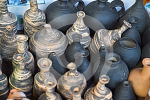 Natural traditional clay pottery beautiful old kitchen appliances, dishes, jugs, vases, pots, mugs. The background
